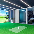 Modern Entertainment Room With Simulated Golf Large Screen Green Turf And Comfortable Lounge Area