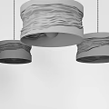 Three Modern Pendant Lights With Wavy Metal Shades And Warm Illumination