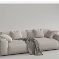 Cozy Beige Double Sofa with Soft Cushions and Black White Striped Blanket