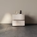 Modern Minimalist Bedside Table With Round Clock And Small Black Sculpture Against Light Colored Wall