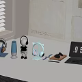 Modern Over Ear Headphones And Blue Bluetooth Speaker With Cat Ear Stand On Desktop Table