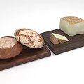Fresh Baked Bread Loaves And Cheese Slices Arranged On Wooden Boards