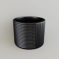 Modern Black Ceramic Vessel with Vertical Striped Texture on Light Background