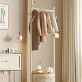 Modern Minimalist Coat Rack with Light Colored Coats and Handbags in Indoor Bedroom Corner with Decorative Lamp