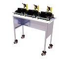 Three Industrial Yellow Black Devices On White Portable Rolling Table Stand