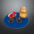 Stylish Gold Teapot With Teacups And Plate Featuring Red And Blue Items On Blue Tray
