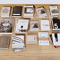 Collection of Books and Magazines with Various Covers on Wooden Floor