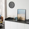 Modern Black and White Shoe Cabinet With Closed Doors Open Compartments And Decorative Top Items