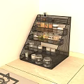 Organized Spice Jars with Black Multi Tiered Wire Rack on Light Colored Kitchen Countertop