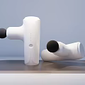 Two White Medical Fascia Massage Guns With Black Heads Standing And Lying