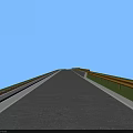 Municipal Road With Vehicles Driving Along Lanes And Roadside Facilities Under Clear Blue Sky