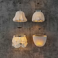 White Pleated Pendant Lights With Four Different Designs On Gray Wall Background
