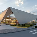 Modern Architectural Building Featuring Geometric Facade Metal Glass Structure And Landscaped Garden Roadway Sunset Sky