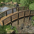 Arched Wooden Garden Bridge Surrounded by Stones Plants and Small Pond