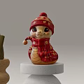Red Snake Shaped Art Installation With Knitted Hat Scarf And Gold Patterns On Wooden Base