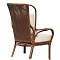 Stylish Rattan Leisure Chair With Armrests Light Colored Cushion And Geometric Pattern Pillow