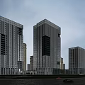 Modern High Rise Office Building Featuring Glass Curtain Wall In Urban Setting With Road And Landscaping