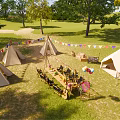 Scenic Garden Landscape With Canvas Tents Green Grass Trees And Bunting Flags