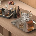 Glass Wine Bottles And Drinking Glasses On Wooden Table With Ice Cubes And Peach Tray