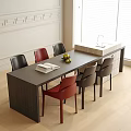 Modern Dining Table Black Red Chairs Open Book Fruit Bowl in Bright Room