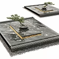 Stylish Water Fountain Design Featuring Square Black Stone Base Small Pine Tree And Golden Border
