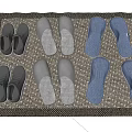 Grey And Blue Slippers With Sneakers Placed On Woven Mat At Home