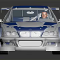 Blue and white race car model with sporty design rear spoiler on black reflective surface
