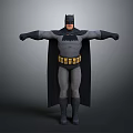 Man in Batman Costume Posing with Arms Outstretched Against Gray Background