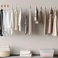 Hanging Clothes In Various Colors With Folded Towels And Transparent Storage Box