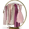 Golden Circular Hanger Holding Various Dresses in Pastel Pink Purple Beige with Lace Tulle Details