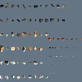 Various Colored Stone Fragments In Different Shapes Arranged On Blue Background