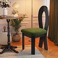 Modern Black Frame Dining Chair With Green Velvet Seat And Unique Curved Back Design