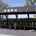Garden Landscape Featuring Traditional Rest Station Pavilion Benches People And Greenery