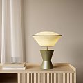 Modern Green Base Table Lamp With Diamond Shaped Light Shade On Wooden Desk