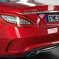 Red Mercedes-Benz Sedan Parked In Spacious Indoor Garage With Tire Tracks On Floor