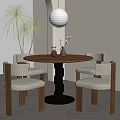 Round Wooden Dining Table With Four Beige Chairs And White Spherical Pendant Light