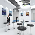 QMF.COM Modern Exhibition Booth With Blue Green Hexagonal Design Display Screens And Professional Staff Interaction