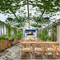 Lush Vine Covered Glass Ceiling Restaurant With Wooden Tables Chairs Indoor Plants And Decorative Painting