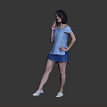 Woman Posing in Blue Off Shoulder Top Blue Shorts and White Shoes Against Gray Background