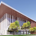 Modern School Building Exterior With Sloped Brown Roof Large Glass Windows And Green Trees
