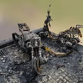 Burnt Motorcycle With Wreckage Ash And Debris In Post Fire Scene