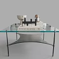 Modern Coffee Table With Glass Top Metal Legs And Decorative Items On Surface