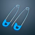 Two Shiny Silver Safety Pins With Blue Heads On Dark Background