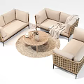 Beige Wicker Outdoor Sofa Set With Round Coffee Table Throw Blanket And Woven Rug