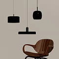 Modern Pendant Lights With Transparent Glass Shades And Black Metal Frames Near Wooden Chair