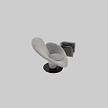 Gray Upholstered Lounge Chair With Curved Shape And Book Holder With Books