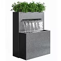 Modern Garden Accent Featuring Black Water Fountain Structure With Green Plants And Flowing Water