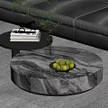 Round Marble Coffee Table With Bowl of Green Apples and Side Table With Books