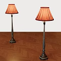 Two Floor Lamps with Red Lampshades and Dark Metal Poles on Herringbone Wooden Floor