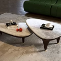 Two Modern Coffee Tables With Marble Tops Dark Legs Featuring Books Cup And Red Fruits